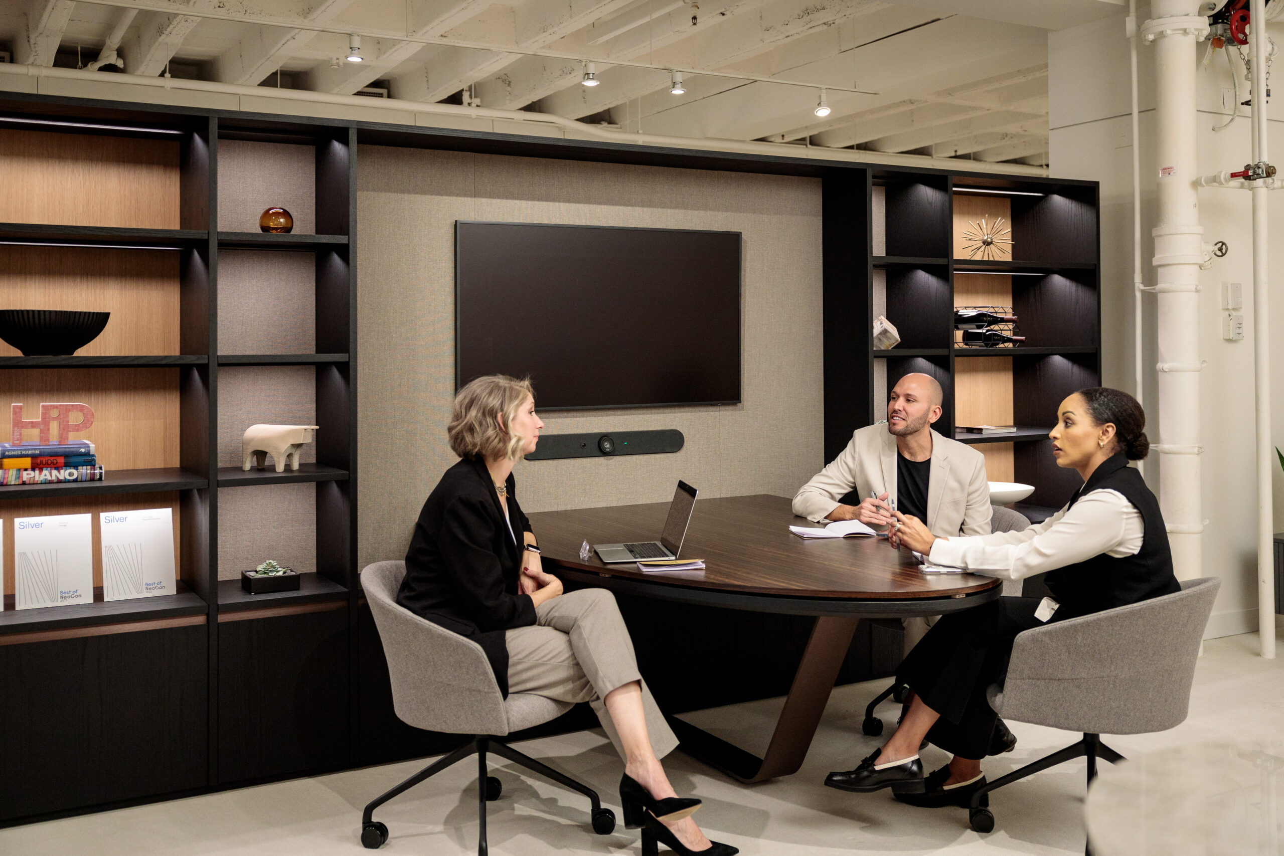 Two Point team members sitting in conference office.